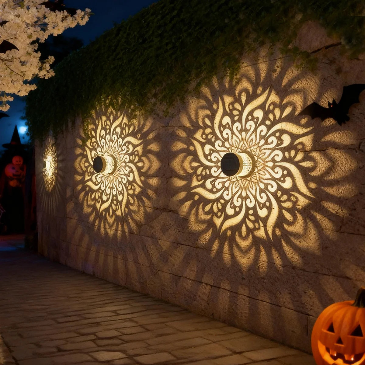 Solar wall lanterns casting mandala patterns on an outdoor wall at night