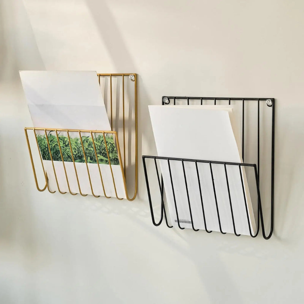 Gold and black iron wall racks mounted, each holding envelopes and documents