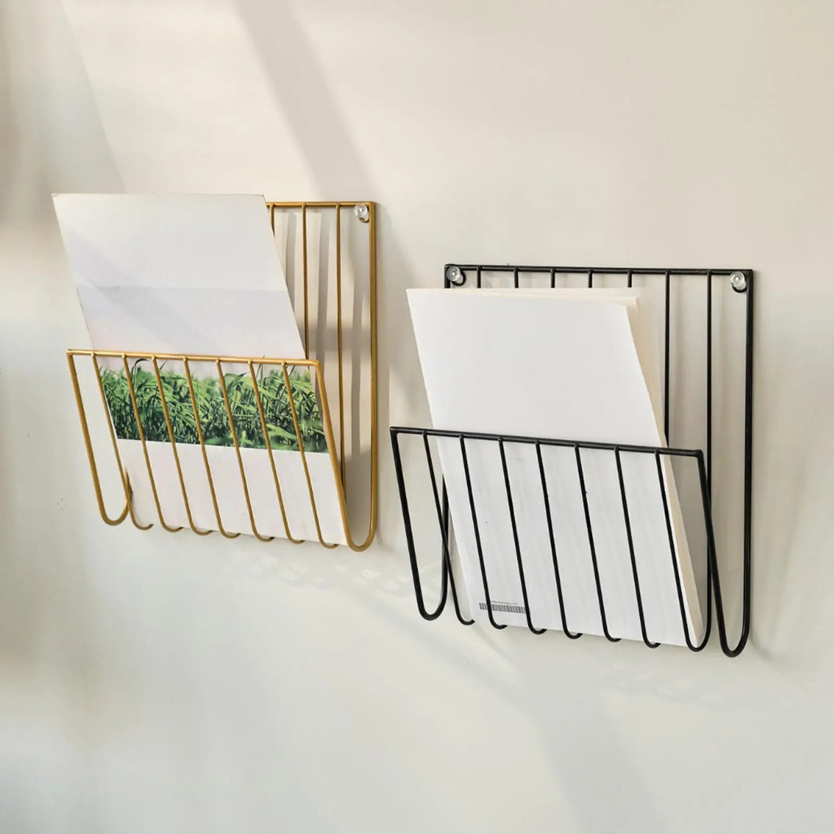 Gold and black iron wall racks mounted, each holding envelopes and documents