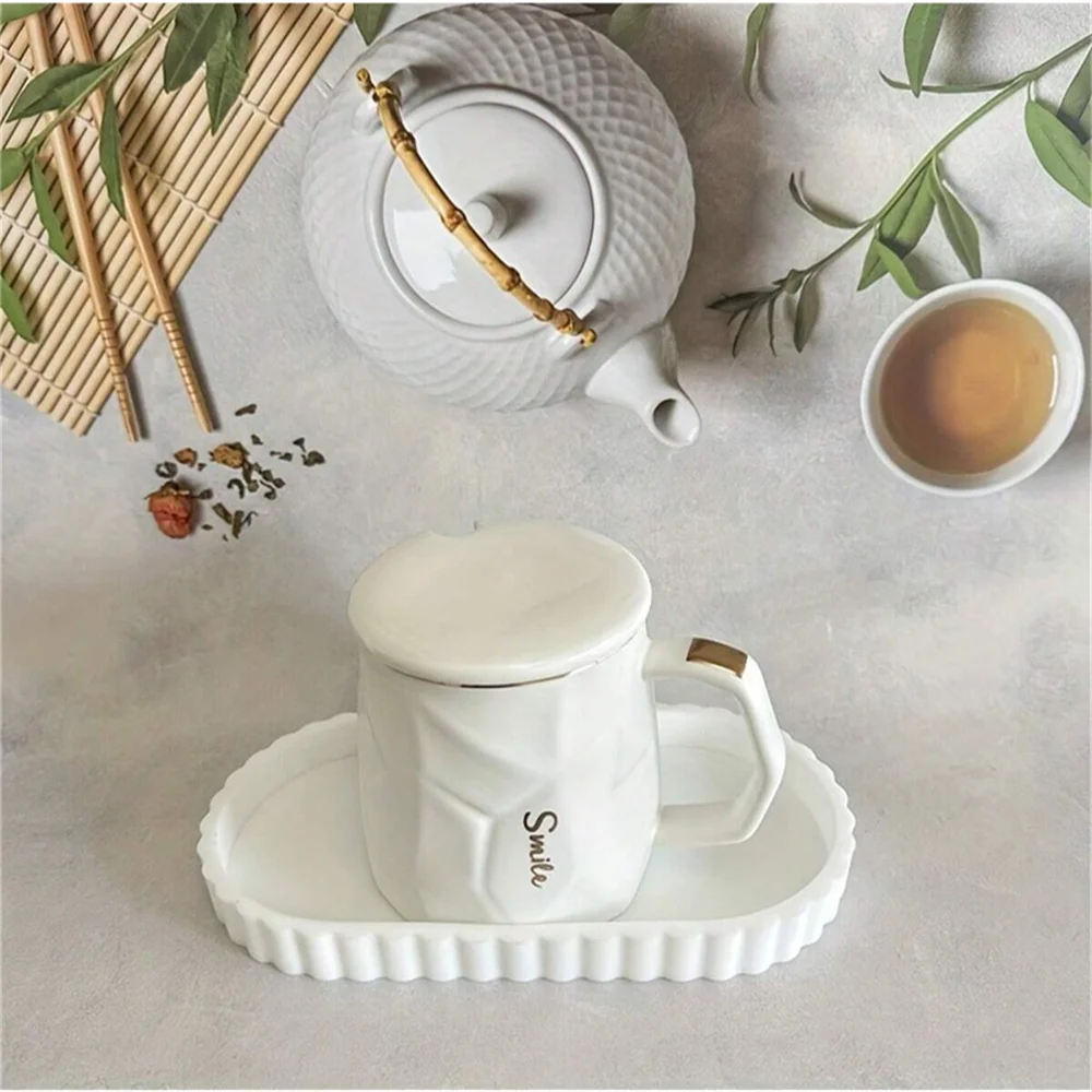 White scalloped silicone tray with a mug on a tea setup