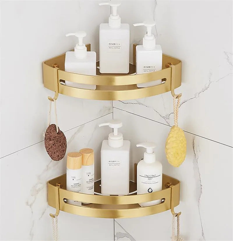 Brushed gold aluminum corner shower shelves with bath bottles and accessories, wall-mounted in a tiled bathroom
