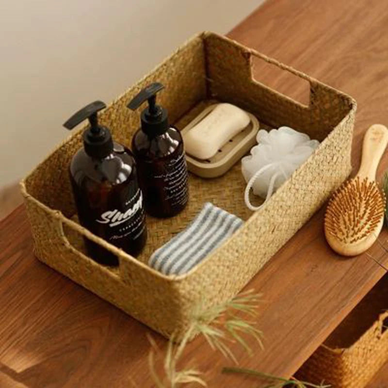 Natural seagrass basket organizing toiletries and a hairbrush on wood surface