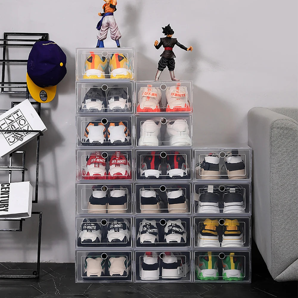 Multiple clear shoe boxes stacked in various configurations near a couch, filled with sneakers