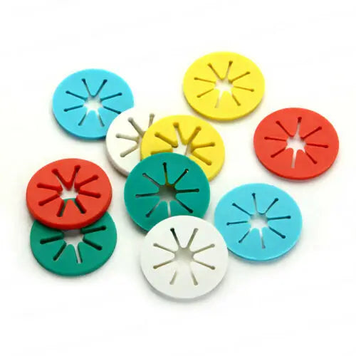 Pile of colorful sock holder clips for laundry organization, viewed from above