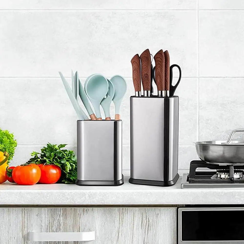 Stainless steel utensil holders on a kitchen counter next to cooking utensils and knives