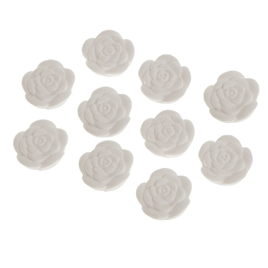 Ten white rose-shaped aroma stones for diffusing essential oils, angled view