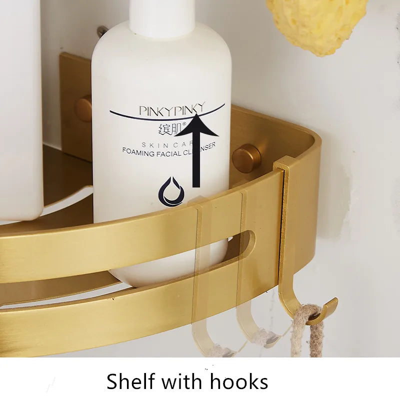 Close-up of the brushed gold shelf hook holding a stringed item in a bathroom setting
