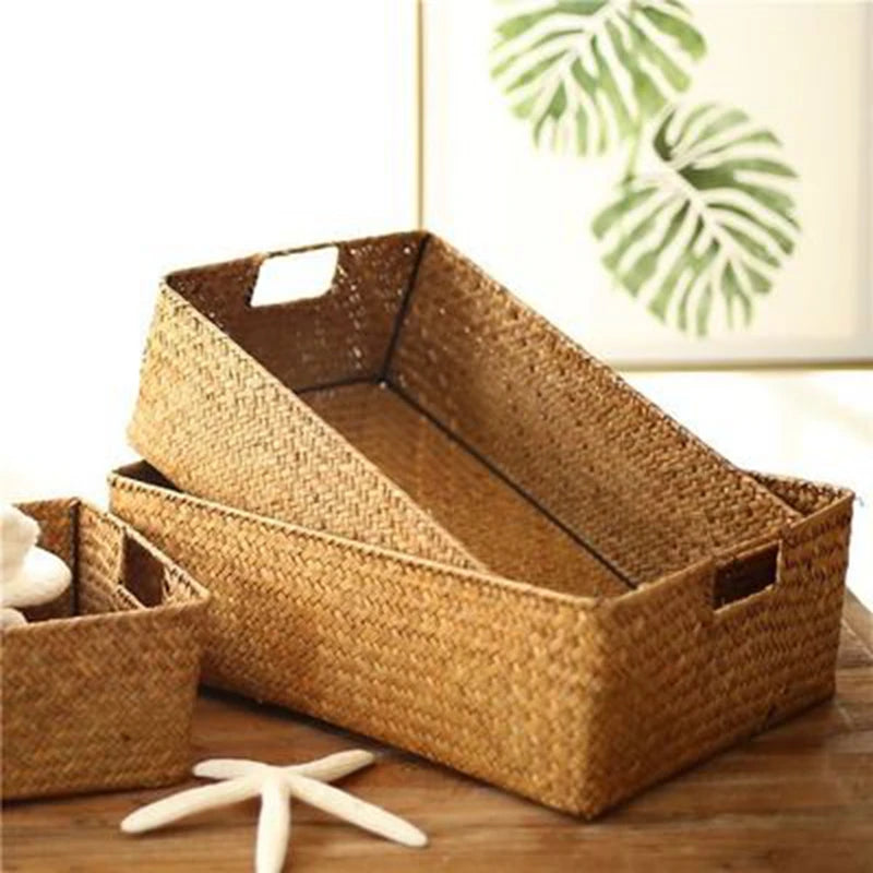 Stacked empty rectangular wicker baskets with handles in natural light