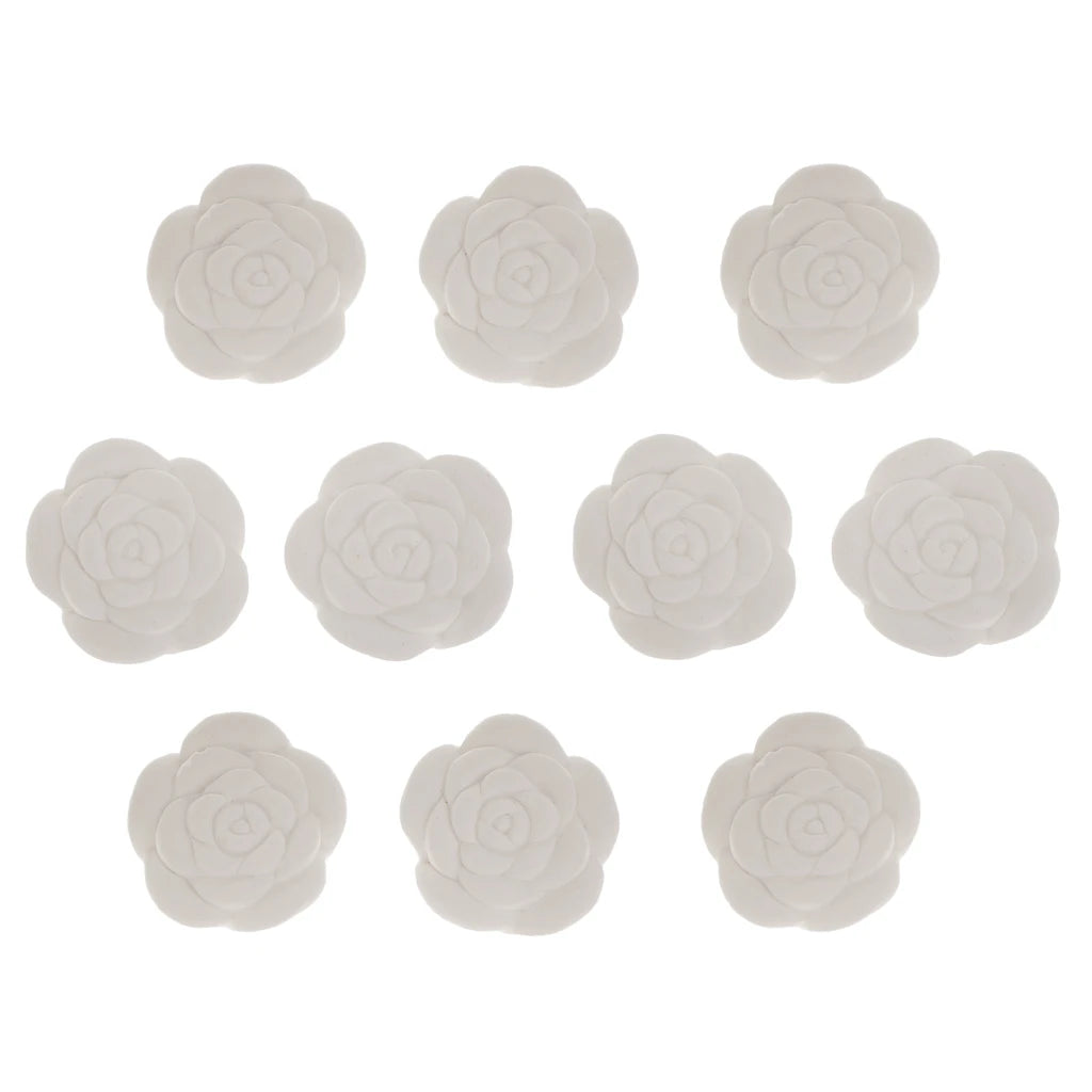 Set of ten rose-shaped white aroma stones arranged in rows on a white background