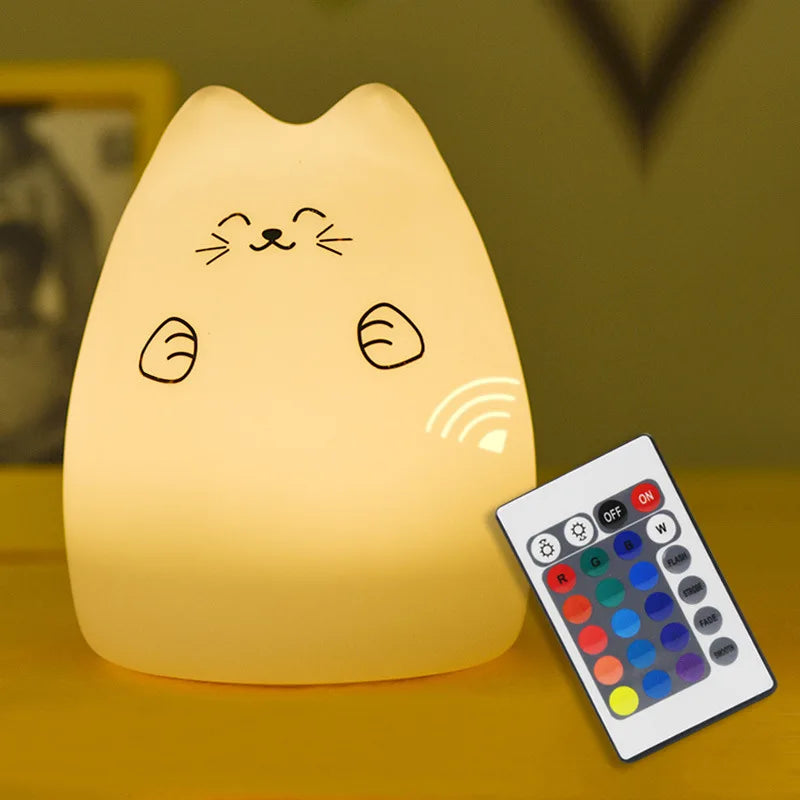 cream colored silicone cat night light with remote control on yellow table