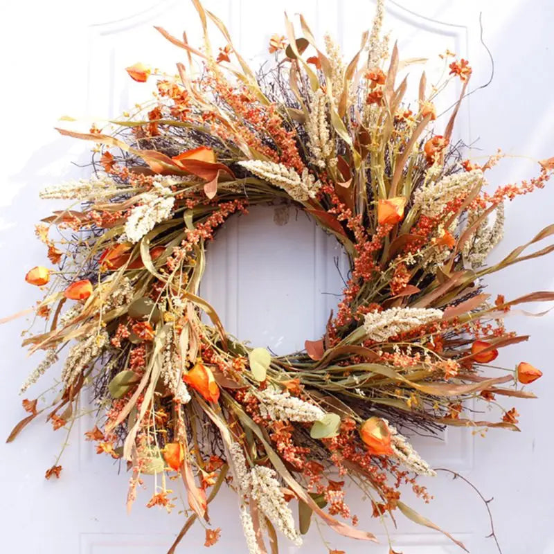 Artificial autumn front door wreath with wheat ears and orange botanicals in a round shape