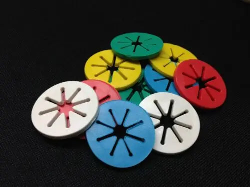 Assorted red, green, yellow, blue, and white sock holder clips on a black background