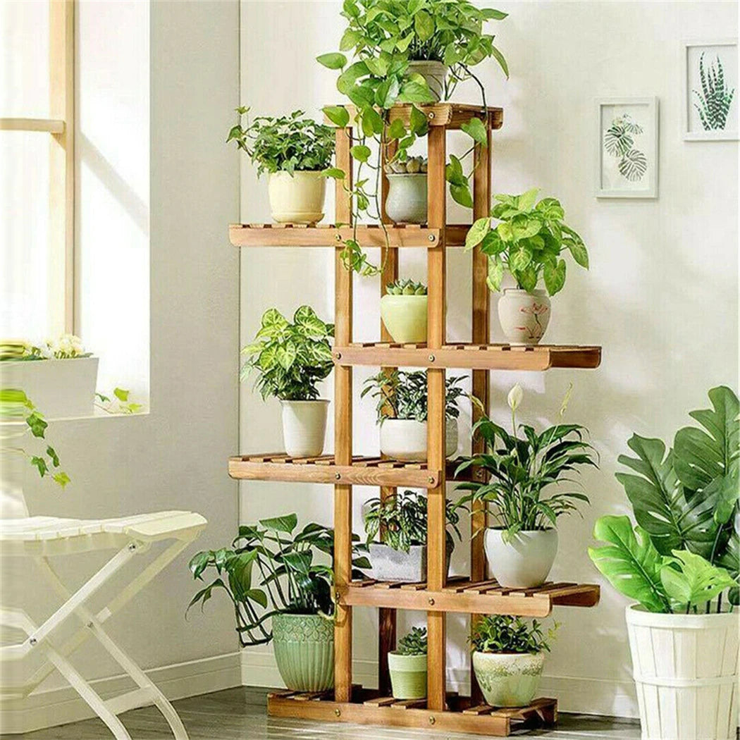 Wooden 6-tier plant stand holding various green indoor plants in a corner living room
