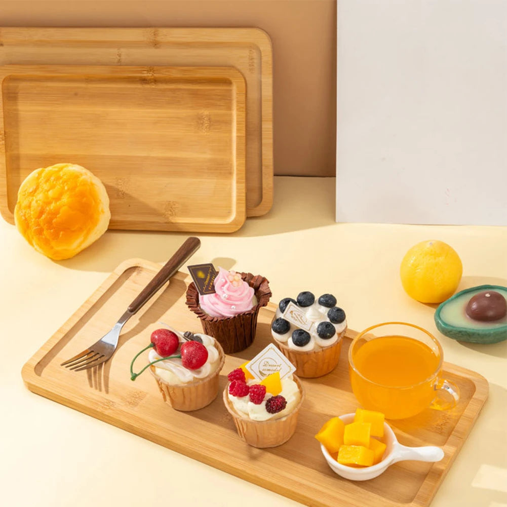 Rectangular wood serving trays on a table with pastries and drinks