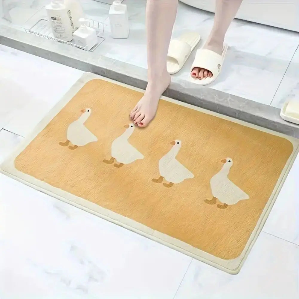 Foot on beige cartoon duck bath mat next to bathtub, slippers in view