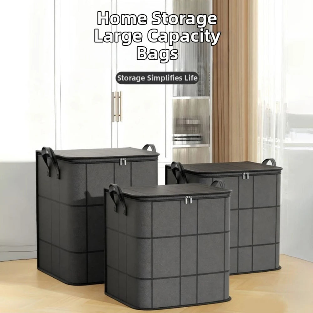 Three large black and grey fabric clothing storage bags with zippers and handles, staged in front of a wardrobe in a bright room.