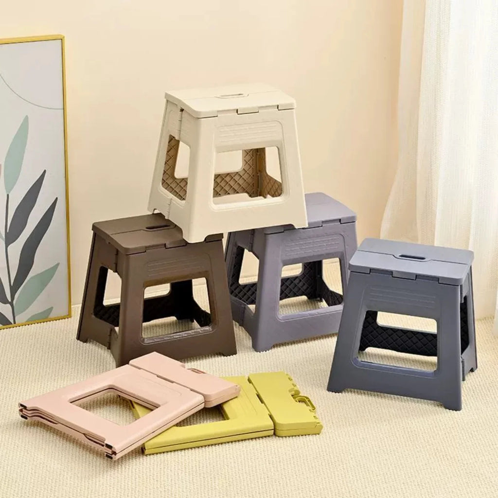 Stacked and flat folding step stools in several colors with decorative print, displayed on a beige carpet
