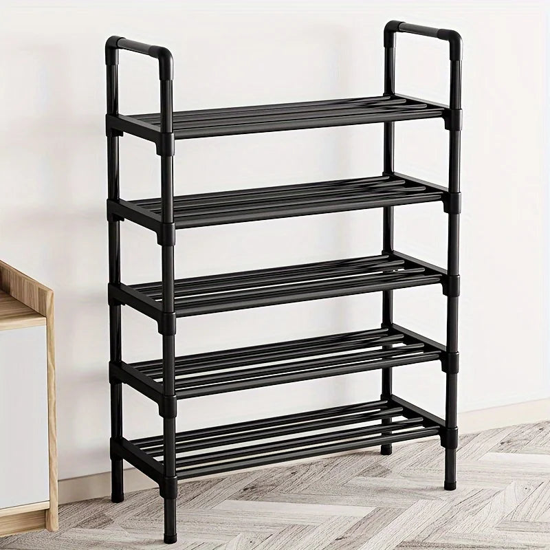 Empty black five-tier shoe rack against a white wall in a bedroom or hallway