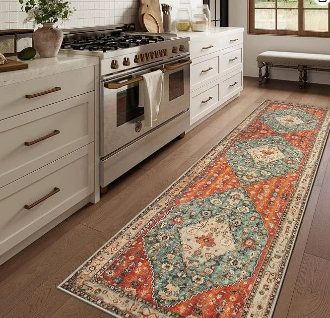 Colorful vintage trellis runner rug in a bright kitchen beside a stove and white cabinetry