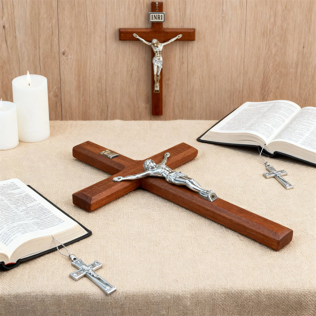 wooden crucifix displayed on a tabletop with open Bibles and candles