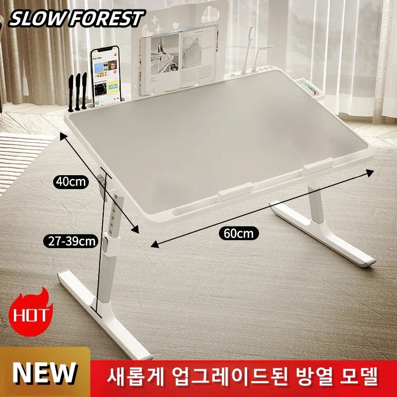 Rectangular adjustable laptop bed tray table set up in a bright bedroom with visible height and length dimensions indicated