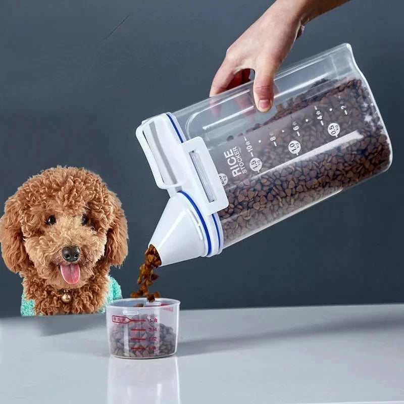 Airtight pet food storage container with handle and measuring cup pouring kibble into a cup beside a dog