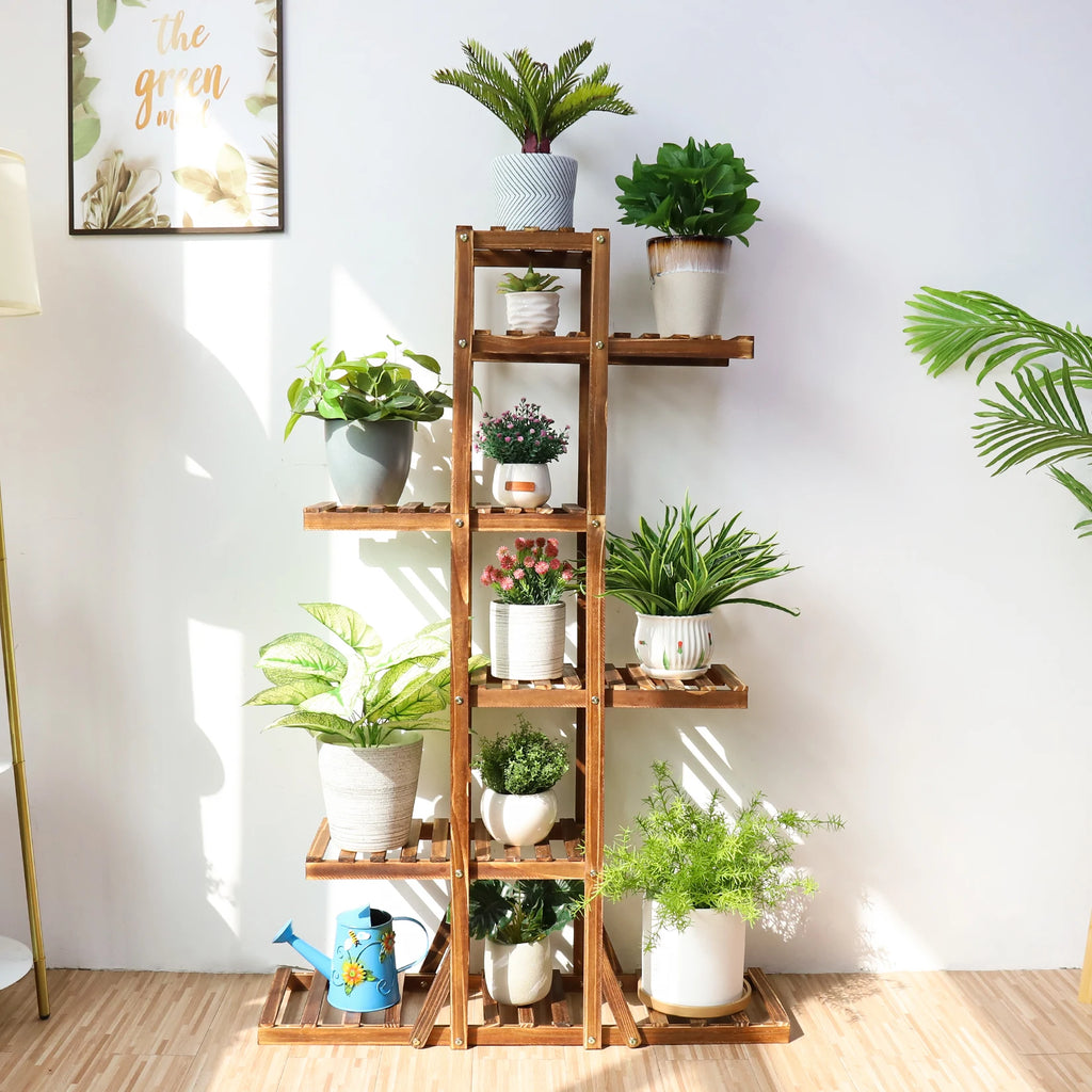 Brown plant stand with multiple shelves arranged with potted plants in a sunlit room