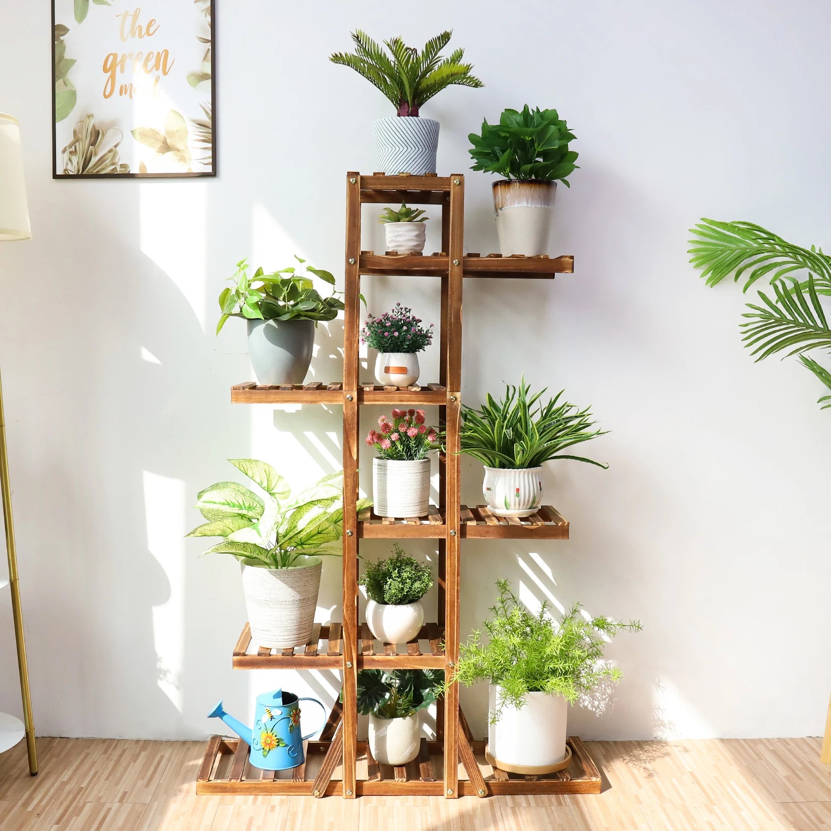 Brown plant stand with multiple shelves arranged with potted plants in a sunlit room