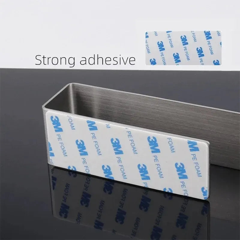 Close-up of brushed steel self-adhesive strip on the back of a towel rack