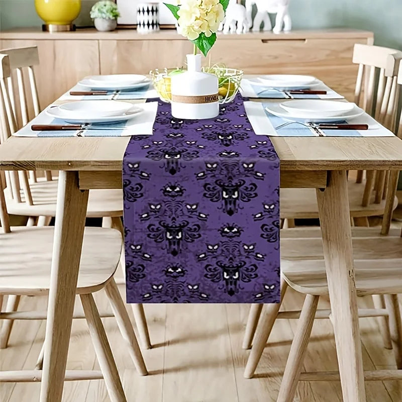 Ghost motif Halloween linen runner on wooden dining table set for a seasonal meal