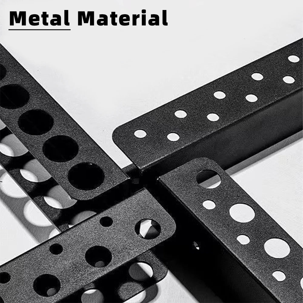 Close-up of black iron tool racks showing texture and multiple circular holes for tool handles.