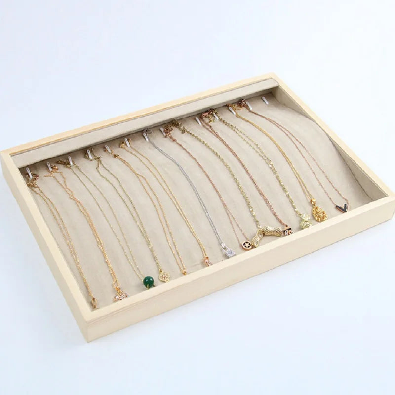 Necklace organizer tray with velvet lining and slots for hanging multiple gold and silver necklaces neatly