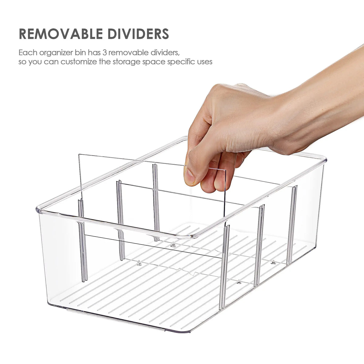 Hand removing divider from clear compartment organizer bin