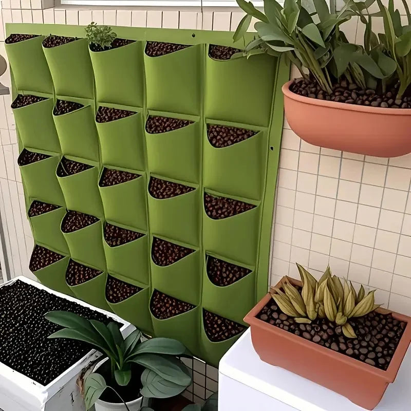 Green vertical wall planter filled with clay pebbles and plants on a balcony wall