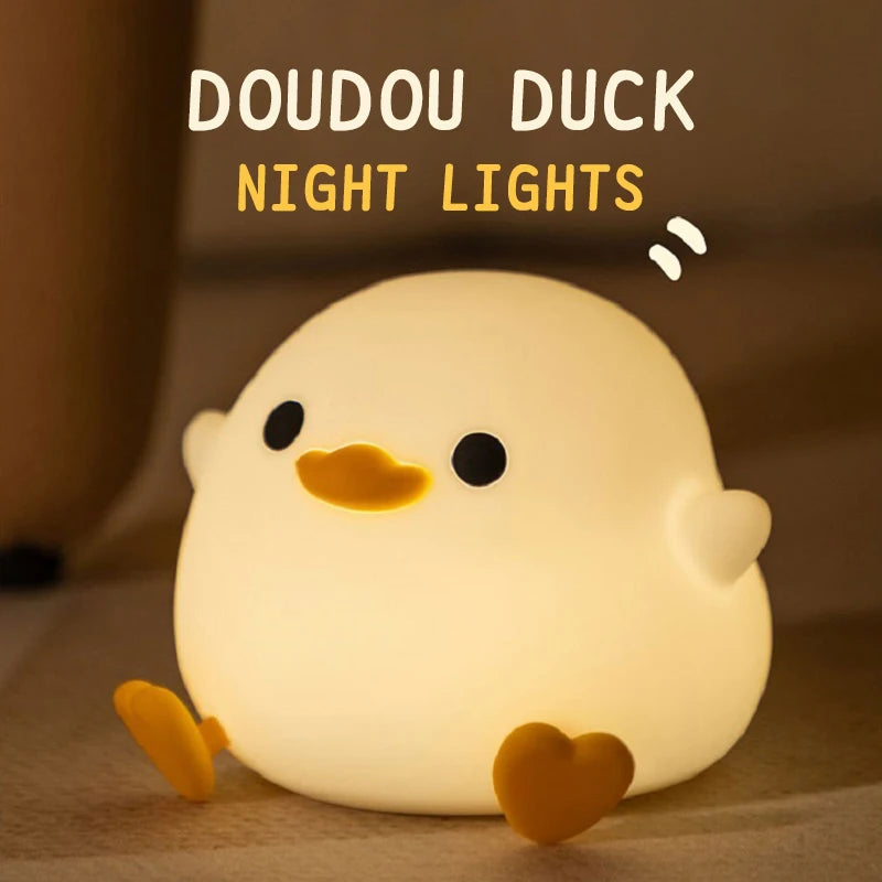 Round silicone duck night light glowing softly in a cozy room