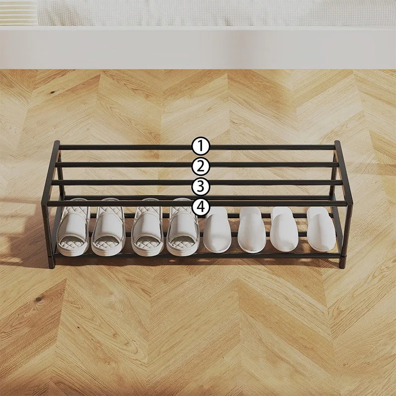 Top view of an empty black two-tier shoe rack with four horizontal bars and slippers lined up
