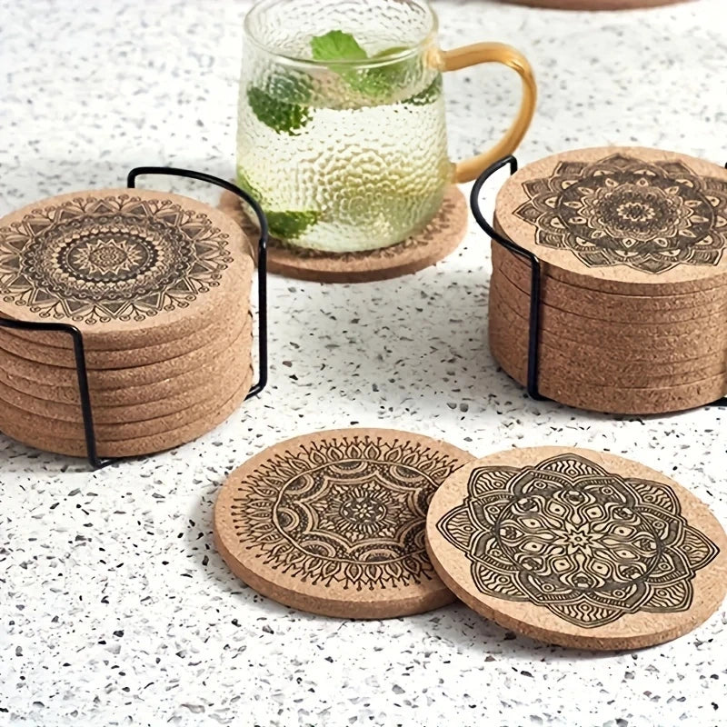 Round wooden coasters with black mandala patterns in metal holder on a kitchen countertop