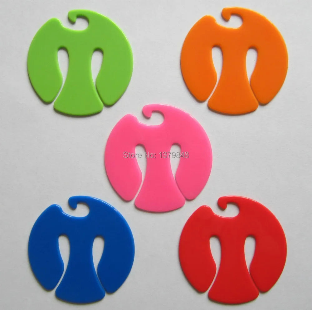 Set of five colorful plastic sock clips in green, orange, blue, pink, and red for organizing pairs