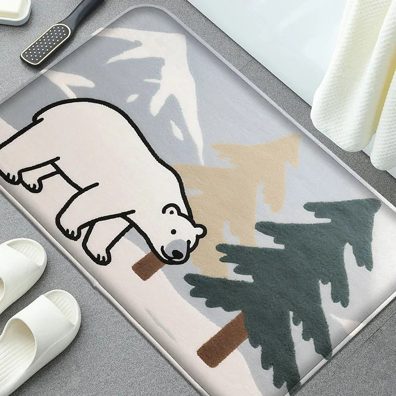 Cartoon anti-slip bath mat with polar bear and trees laid in front of a tub