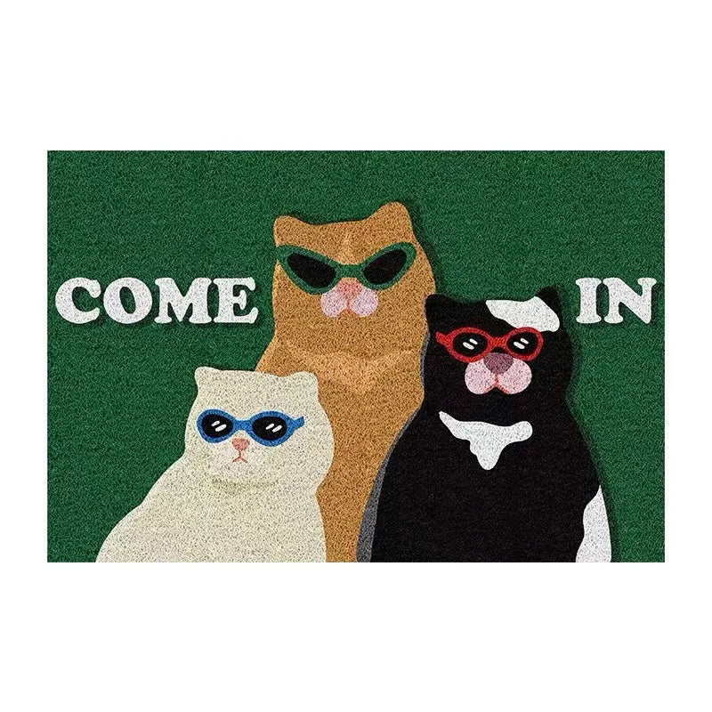 green PVC doormat with three cartoon cats wearing sunglasses and 'COME IN' text
