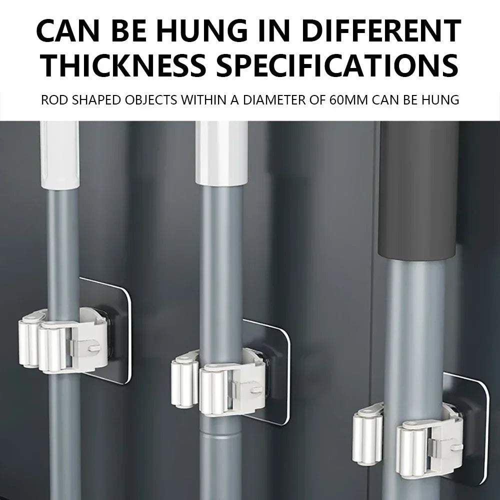 Three mop and broom holders on a wall holding poles of different diameters