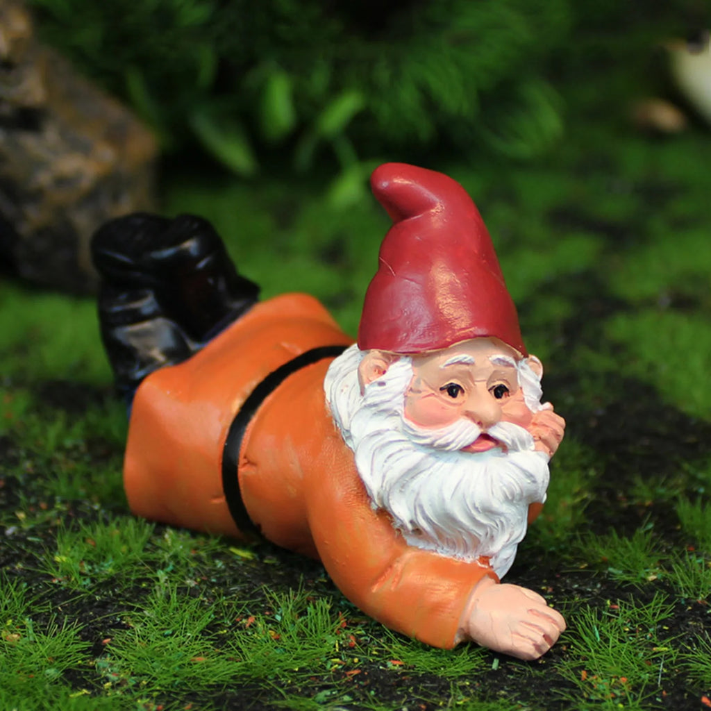 Small resin gnome figure lying on its stomach in the garden, ideal for patio or indoor display