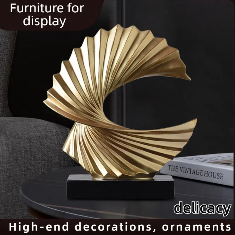 gold wave resin tabletop sculpture on side table with books, art deco style
