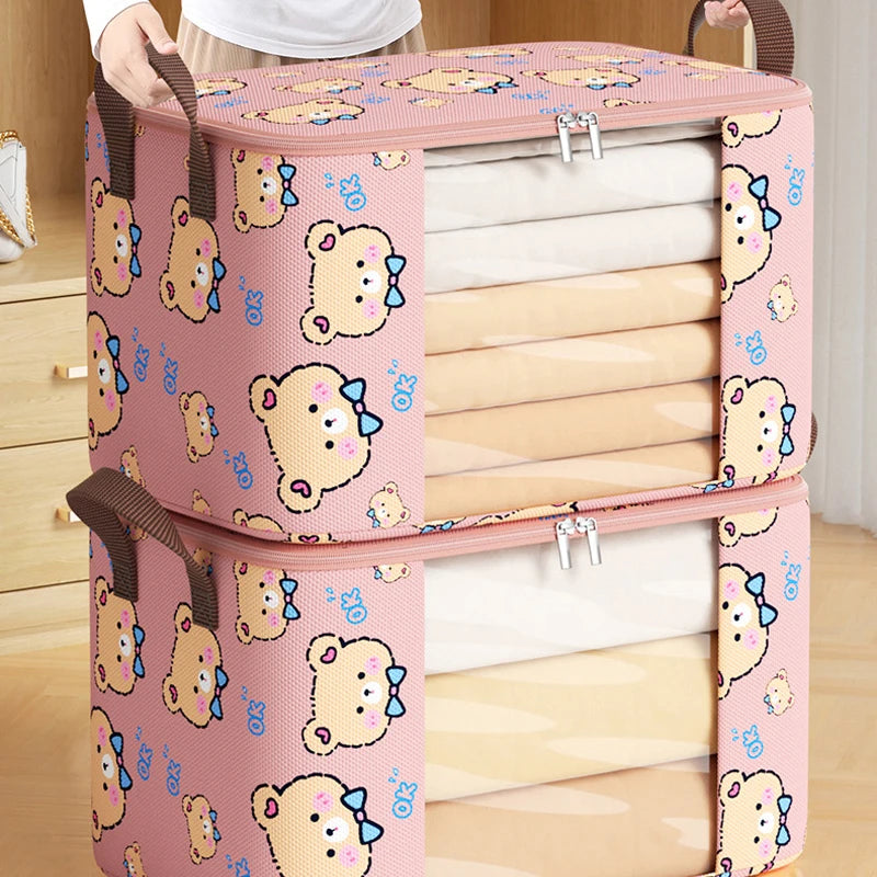 Close-up of stacked bear print storage bags with handles, packed full of bedding and clothing