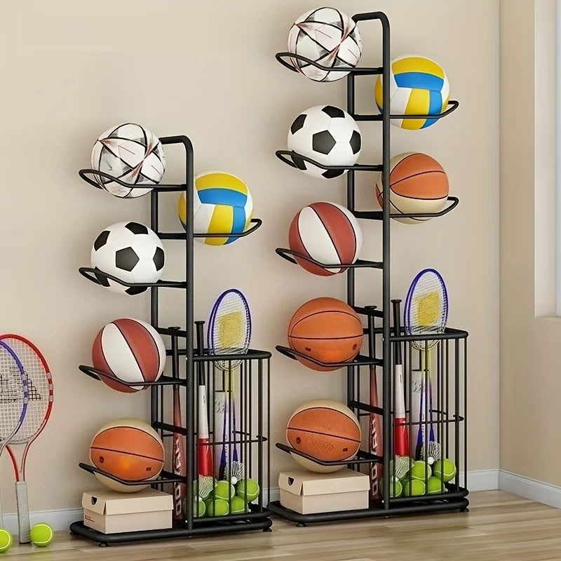 Two upright black ball storage racks filled with sports balls, rackets, and bats against a wall