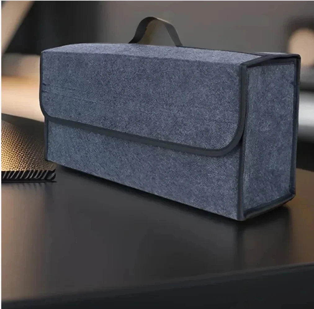 Grey felt car trunk organizer box on a table showing texture and handle