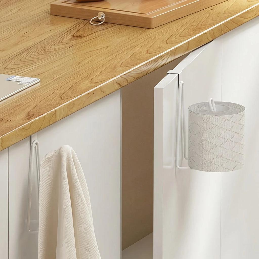 white over cabinet holder on an open kitchen cabinet door holding a toilet paper roll and a dish towel