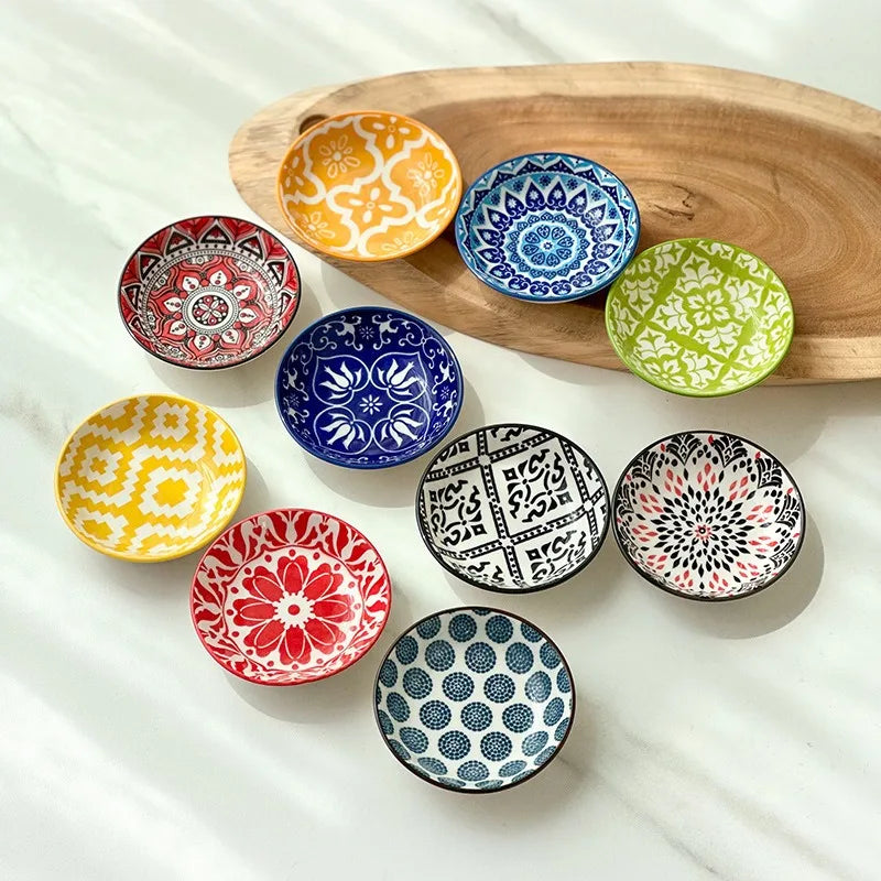 Set of 10 round ceramic dishes in assorted mandala and boho patterns arranged on a table