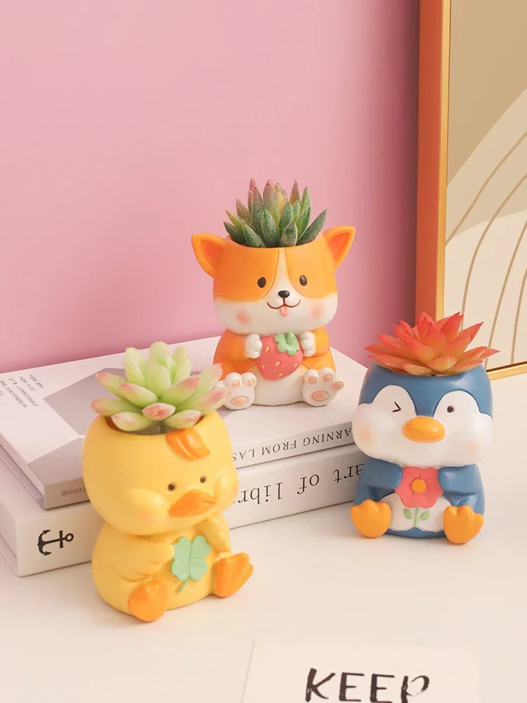 Duck, Corgi, and Penguin animal resin planters holding mini succulents on a desk