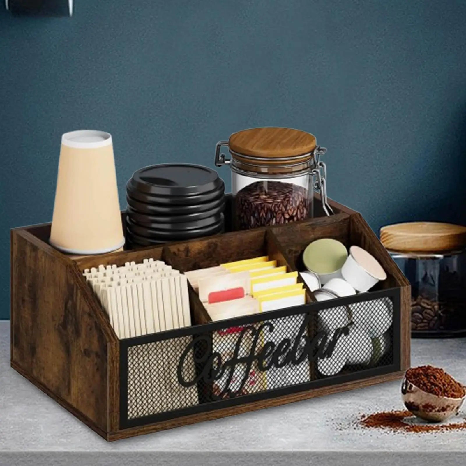 coffee bar organizer on a counter with coffee supplies, against a blue wall